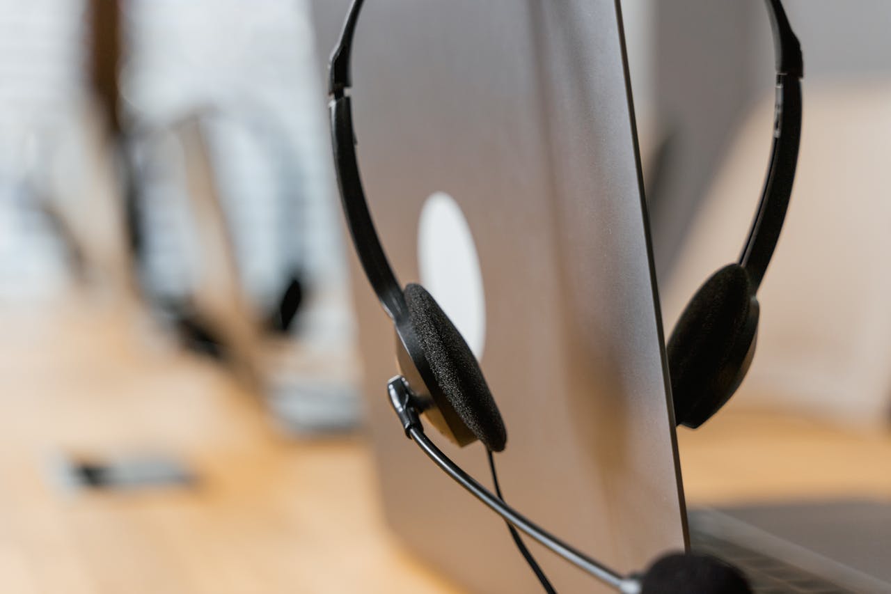 Close-up of a headset resting on a laptop, symbolizing efficient work environment technology.